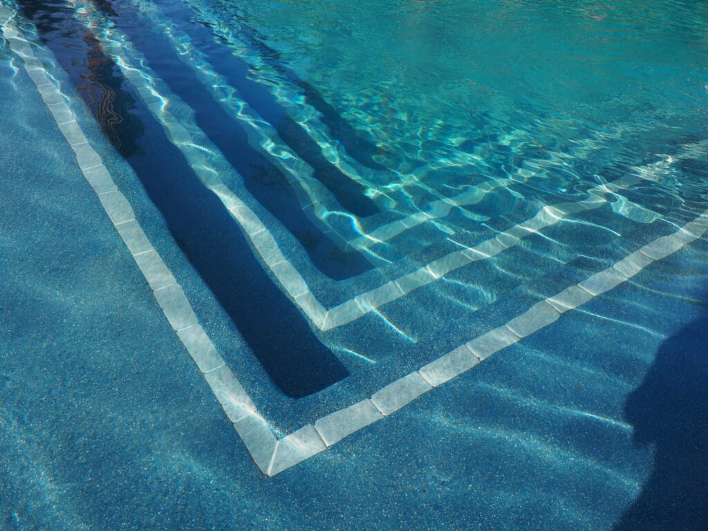 Close-up of a pool area with visible calcium buildup, relevant for pool wash calcium removal techniques.