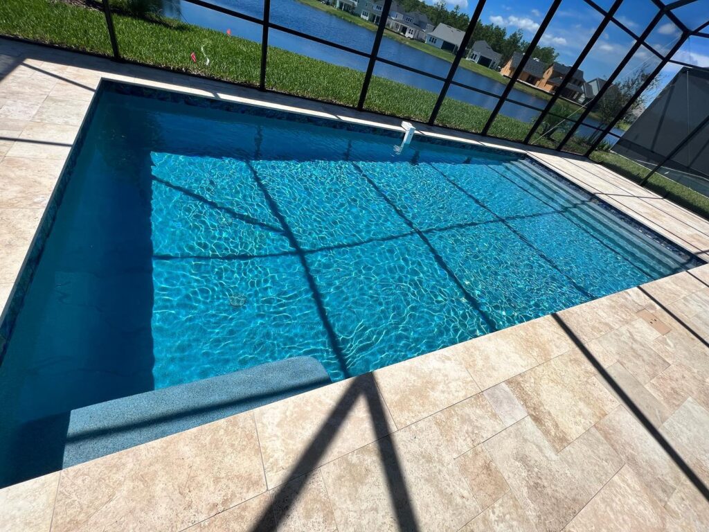 A clean pool surface after pool wash calcium removal, showcasing bright blue water and clear plaster.